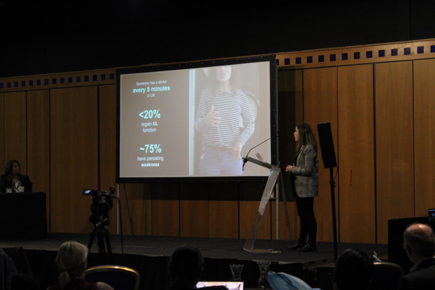 Woman presenting her topic on stage